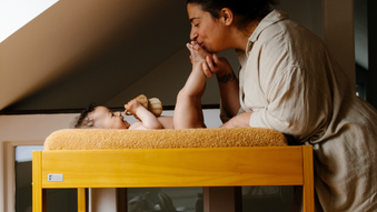 mother changing baby's diaper