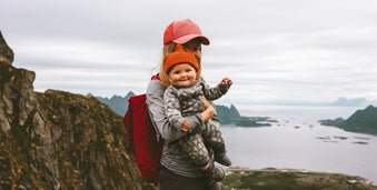 Mother holding baby by cliffs