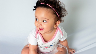 smiling baby looking to the left