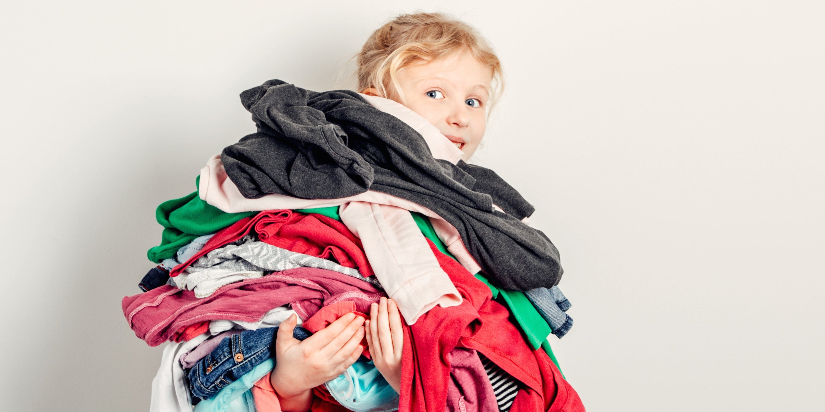 Little girl holding laundry